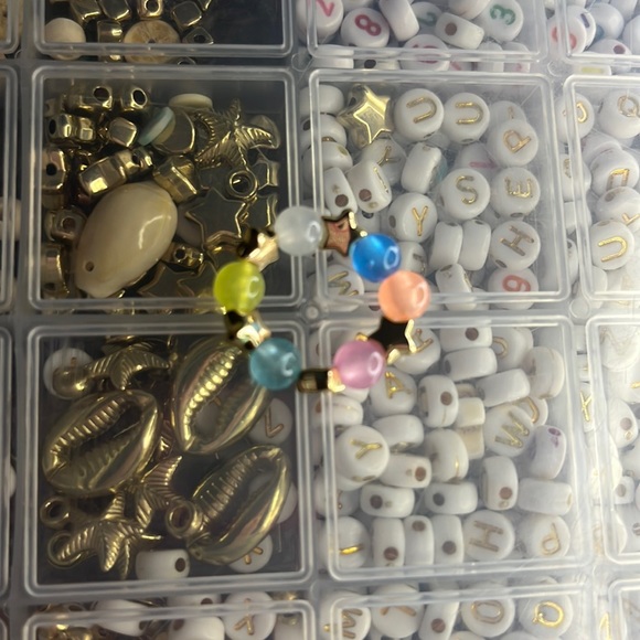 This is a ring with gold stars and beads - Picture 1 of 1